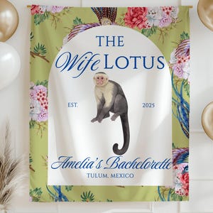 May include: A green backdrop with floral and bird designs, featuring text that reads "The Wife Lotus" and "Amelia's Bachelorette Tulum, Mexico." A watercolor monkey illustration is centered. Gold and white balloons and a gold vase with dried plants are in the image.