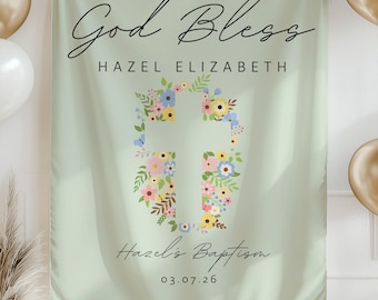 May include: A light green baptism banner with the words "God Bless" and "Hazel Elizabeth" in elegant script. A floral cross design is centered, and the banner includes "Hazel's Baptism" and the date 03.07.26. Gold and white balloons and decorative accents are in the background.