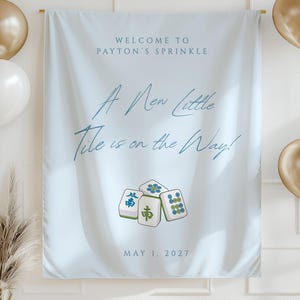 May include: A light blue banner with the text "WELCOME TO PAYTON'S SPRINKLE" and "A New Little Tile is on the Way!" with Mahjong tiles illustrations. The date "MAY 1, 2027" is also displayed. Gold and white balloons and decorative elements are also present.