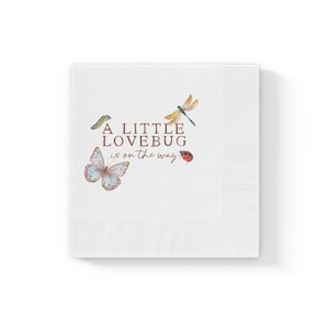 May include: White paper napkins with the text "A Little Lovebug is on the way" and illustrations of a butterfly, dragonfly, ladybug, and caterpillar. The napkins have a textured border.