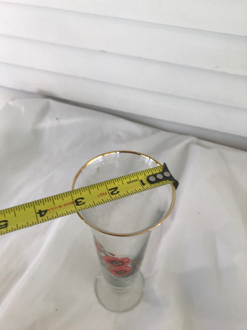 Glass trumpet vase with orange flowers