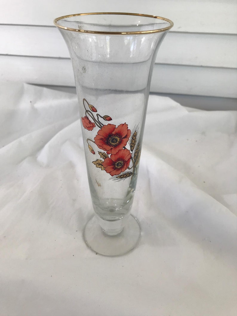 Glass trumpet vase with orange flowers