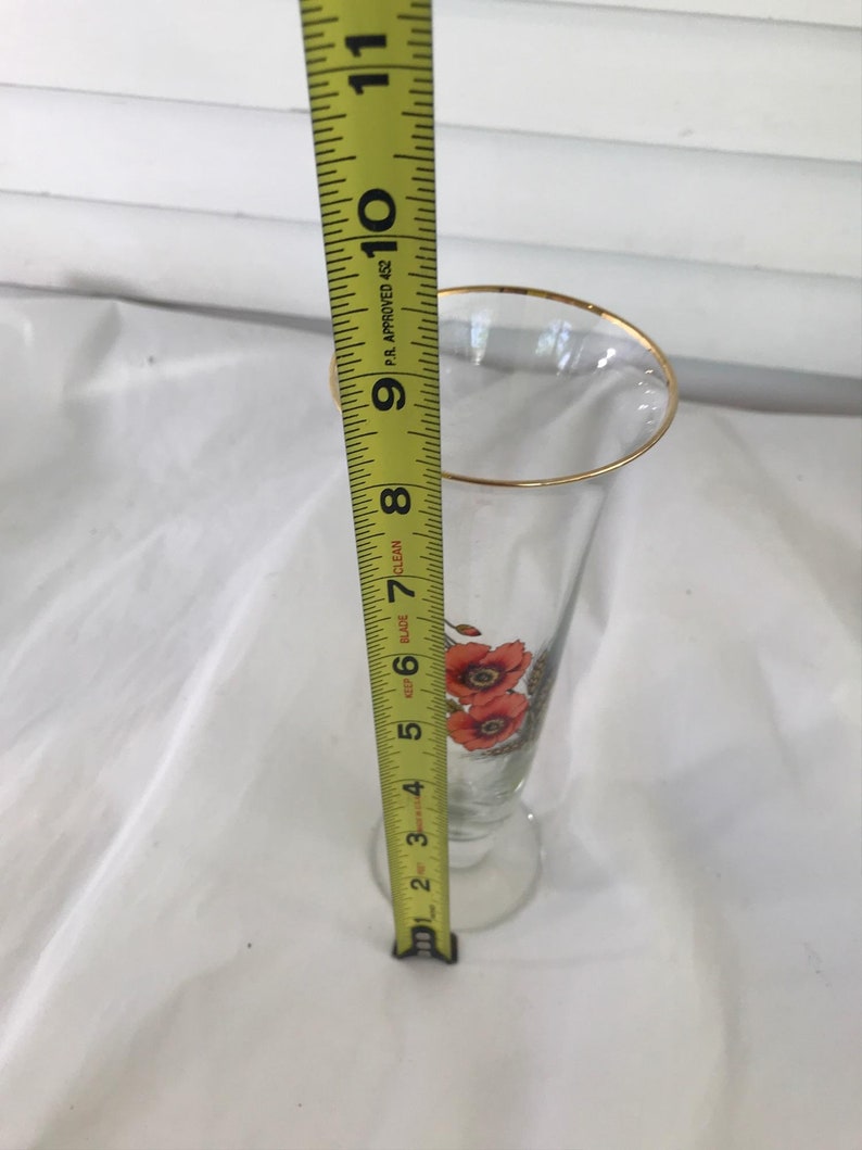 Glass trumpet vase with orange flowers