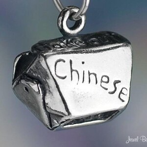 May include: Silver charm in the shape of a Chinese takeout box with the word "Chinese" inscribed on the front.