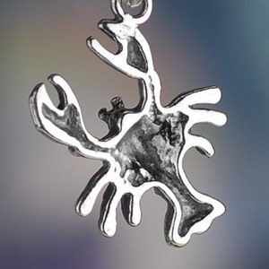 May include: Silver charm in the shape of a crab. The charm is detailed and has a textured surface.