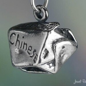 May include: Silver charm in the shape of a Chinese takeout container with the word "Chinese" engraved on the side.