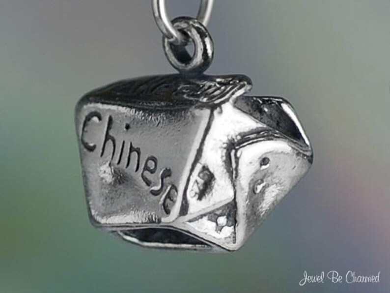 May include: Silver charm in the shape of a Chinese takeout container with the word "Chinese" engraved on the side.