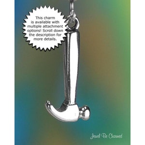 May include: A silver-colored hammer charm suspended from a chain. The charm has a detailed design and is set against a gradient background of blue, green, and yellow. Text on the image states the charm has multiple attachment options.