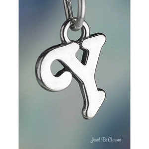 May include: Silver charm in the shape of the letter Y. The charm is designed in a cursive style.