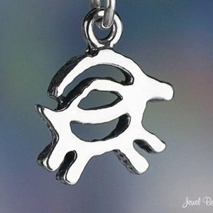 May include: A silver charm in the shape of a stylized animal with a curved body and four legs. The charm is detailed and intricate.