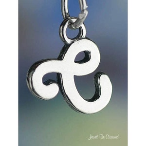 May include: Silver charm in the shape of the letter 'e' with a cursive script style.