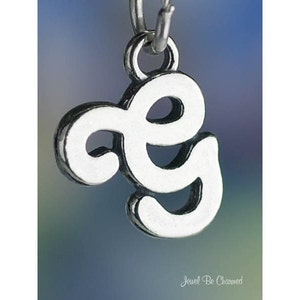 May include: Silver charm in the shape of the letter 'G' with a decorative swirl design.