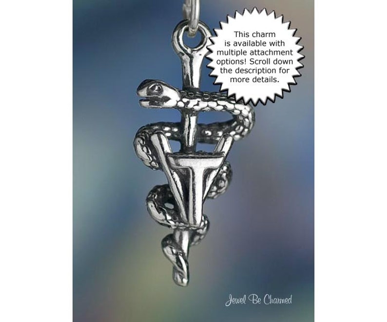 May include: A silver-colored charm featuring the Rod of Asclepius, a symbol of medicine, with a serpent coiled around a staff. The charm has a detailed design and includes the text: "This charm is available with multiple attachment options! Scroll down the description for more details."