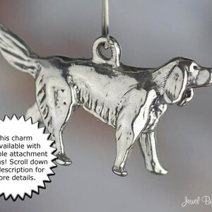 May include: Silver charm of a dog, possibly a pointer breed, in a walking pose. The charm is available with multiple attachment options.