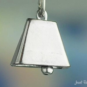 May include: Silver charm in the shape of a bell. The bell is a traditional symbol of good luck and fortune.