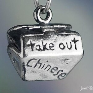 May include: Silver charm in the shape of a Chinese takeout container with the words "take out" and "Chinese" engraved on it.