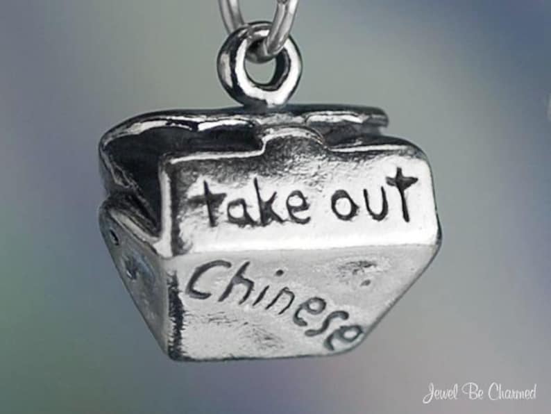 May include: Silver charm in the shape of a Chinese takeout container with the words "take out" and "Chinese" engraved on it.