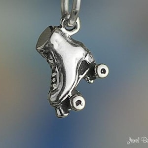 May include: Silver charm in the shape of a roller skate. The skate has a detailed design and is on a silver chain.
