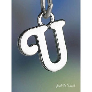 May include: Silver charm in the shape of the letter U. The charm has a simple, elegant design and is perfect for adding a personal touch to jewelry.