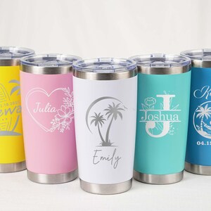 May include: Five stainless steel insulated tumblers in yellow, pink, white, teal, and blue. Each tumbler features a unique design, including names and tropical graphics. The tumblers have silver lids and bases.