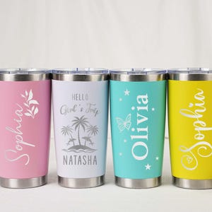 May include: Four stainless steel tumblers in pink, white, teal, and yellow. Each tumbler has a different name in a script font. The pink tumbler has a floral design, the white has a beach scene, the teal has a butterfly, and the yellow has a heart.