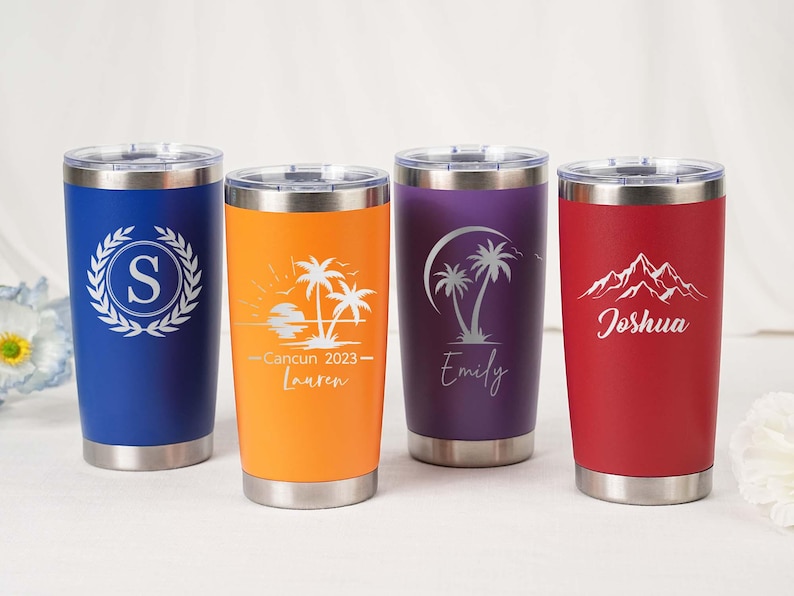 May include: Four stainless steel tumblers in blue, orange, purple, and red. Each tumbler has a silver lid and features a unique design: a monogram, a beach scene, palm trees, and mountains with a name.