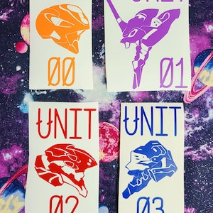 May include: Four white stickers with the text "UNIT" and a number from 00 to 03. Each sticker features a different colored silhouette of a robot head. The robot heads are orange, purple, red, and blue.