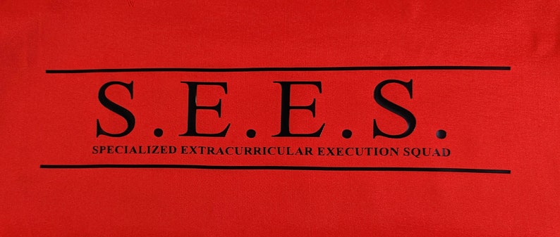 May include: Red t-shirt with black text that reads "S.E.E.S. SPECIALIZED EXTRACURRICULAR EXECUTION SQUAD"