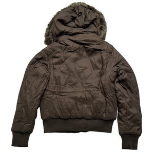 May include: A brown bomber jacket with a faux fur-lined hood. The jacket has a ribbed hem and cuffs. The back of the jacket is visible, showing the quilted design. The jacket is a solid brown color.