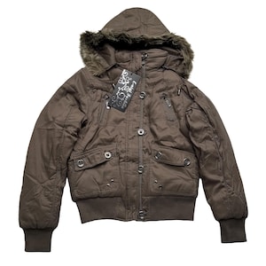 May include: A brown hooded jacket with a faux fur trim around the hood. The jacket has a quilted design, multiple pockets, and a ribbed hem and cuffs. The tag reads "E-migl Fashion".