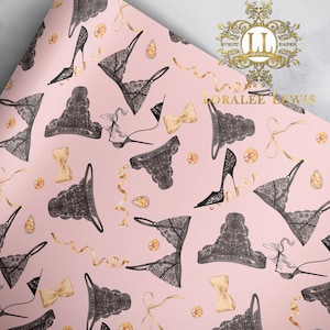 May include: Pink wrapping paper with a repeating pattern of black lace lingerie, gold bows, and gold rhinestones. The text "Loralee Lewis" is printed in the top right corner.