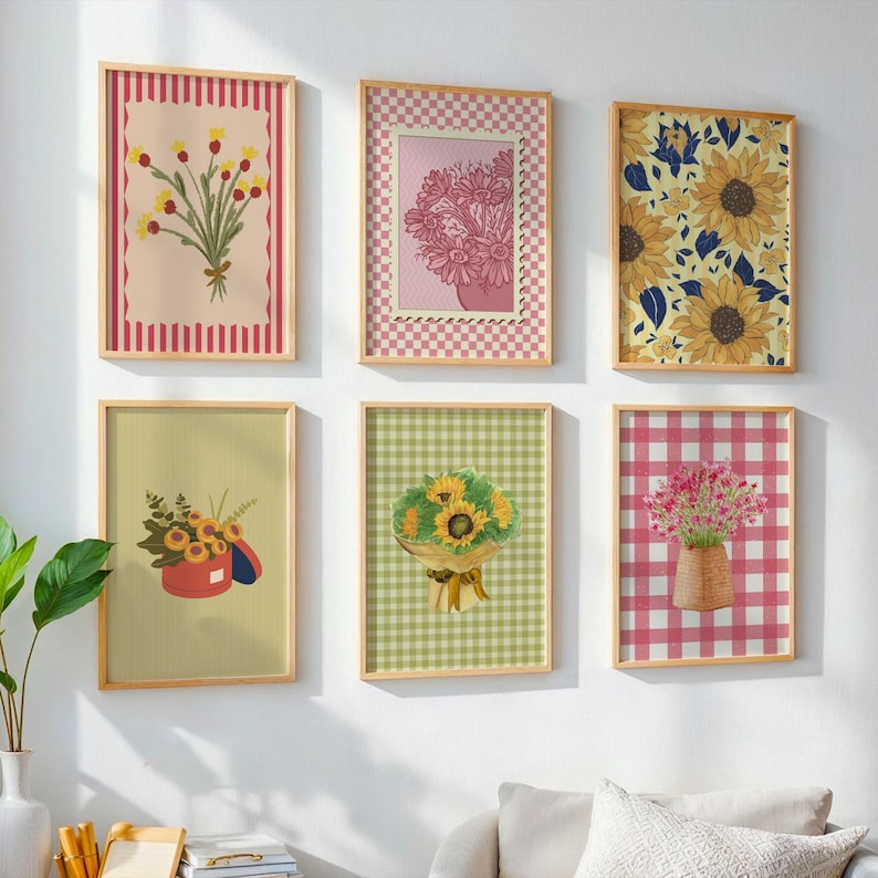 May include: A set of six rectangular wall art prints in light wooden frames. The prints feature various floral arrangements, including sunflowers and wildflowers, set against backgrounds with red stripes, pink checkered patterns, and green gingham.
