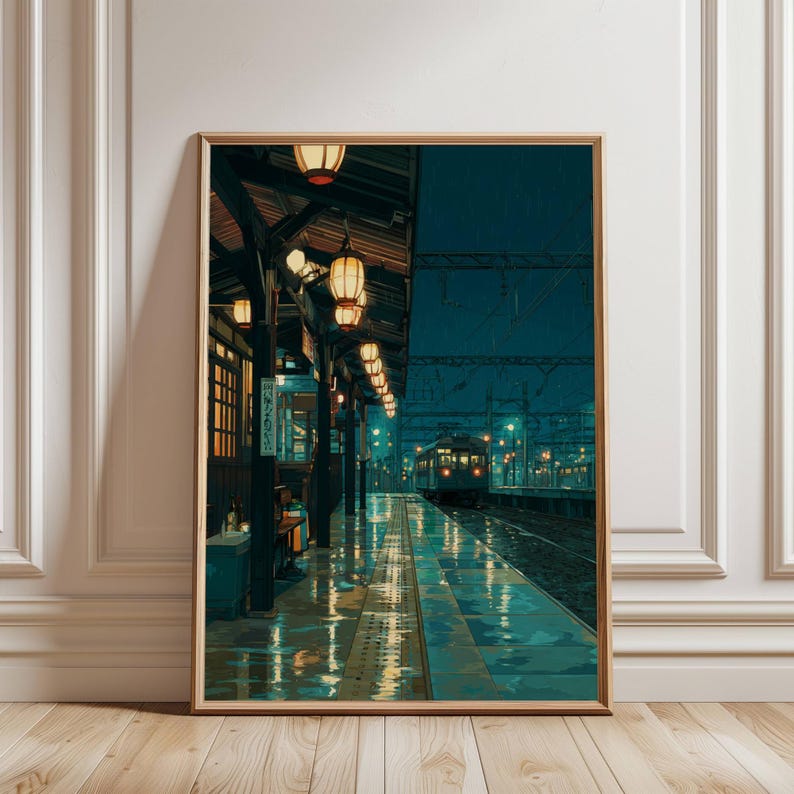 May include: A framed art print depicts a rainy train station scene. The artwork features a long platform with a train in the distance, illuminated by warm-toned lanterns. The wet platform reflects the lights, creating a moody, atmospheric aesthetic.