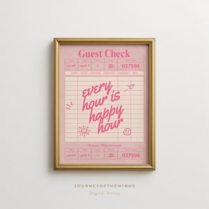 May include: A framed wall art print featuring a pink guest check design with the text "every hour is happy hour" in a cursive font. The print includes small hand-drawn icons like a sun, a smiley face, and a paper airplane on a grid background.