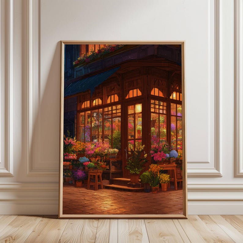 May include: A framed print of a flower shop at dusk. The shop has large windows filled with colorful flowers and plants. The exterior is dark wood with a blue awning. The scene is illuminated by warm interior lights.