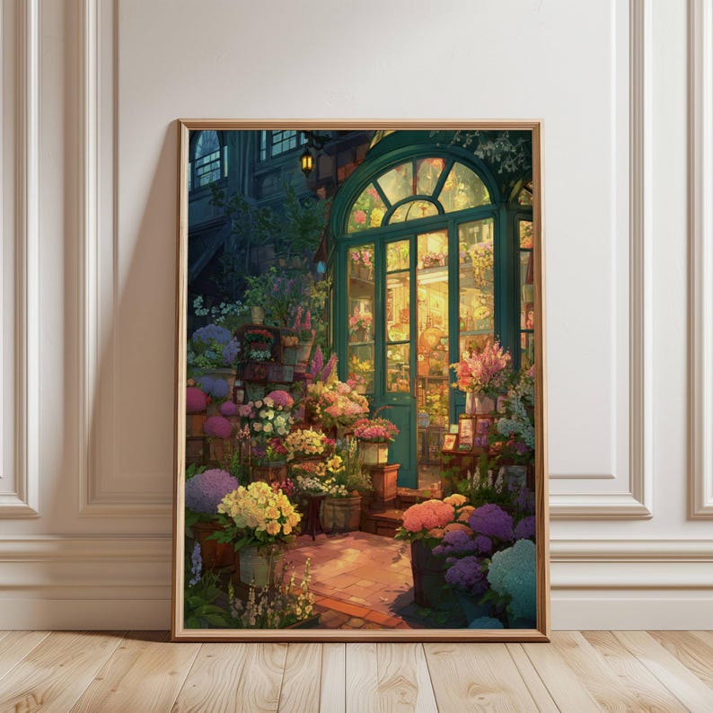 May include: A framed print of a flower shop at dusk. The shop has a teal arched doorway and is filled with colorful flowers. The interior is warmly lit, and the scene is surrounded by lush greenery and other flowers in pots.