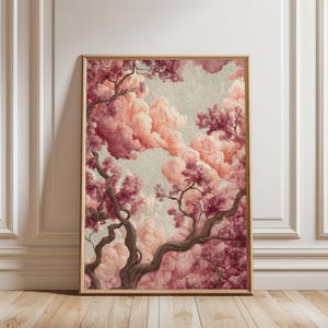 May include: A framed art print featuring a dreamy landscape with pink and red flowering trees and fluffy clouds. The artwork has a vintage aesthetic, with a light beige background and a wooden frame.