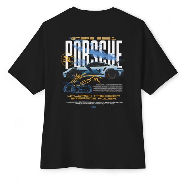 May include: A black short-sleeve t-shirt featuring a graphic on the back with the text PORSCHE, GT3RS 992.1, and UNLEASH PRECISION EMBRACE POWER. The design includes a light blue sports car illustration, a gold signature, and technical text.
