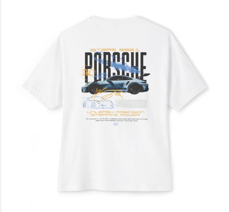 May include: A white t-shirt featuring a graphic on the back with the text PORSCHE, GT3RS 992.1, UNLEASH PRECISION EMBRACE POWER. The design includes a blue sports car illustration, technical line drawings, and orange accents.