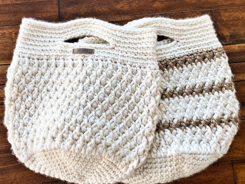 May include: Two crocheted bags, one white and one with brown stripes. Both bags have a handle and are made with a textured stitch.