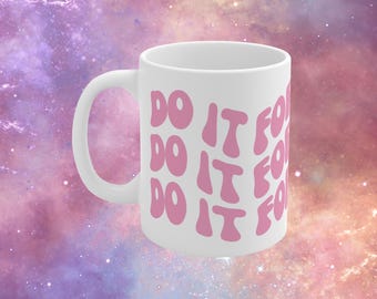 May include: White ceramic mug with a curved handle. The mug features the phrase "DO IT FOR" in pink, repeated three times down the side. The background is a colorful galaxy design with shades of purple, pink, and blue.