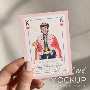 May include: A Valentine's Day card mockup featuring a playing card design with a king illustration. The card has a pink border and the text "Happy Valentine's Day!" and "For the king of my heart". The card measures 2.5 x 3.5 inches.