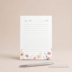May include: A white notepad with lined pages, floral border, and the words "My Notes" and "Date" in script. A silver pen rests on the surface. The notepad is 5x7 inches.