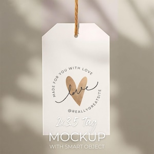 May include: A white tag mockup with a gold heart and the word "love" in cursive. The tag reads "Made for you with love" and "@reallygreatsite". The tag also says "2x3.5 Tag Mockup with smart object". A brown string is attached.