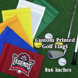 May include: A collection of custom printed golf flags in various colors, including red, blue, yellow, white, and green. The flags are 8x6 inches. The image also shows golf balls, a golf club, and the text "Custom Printed Golf Flags."