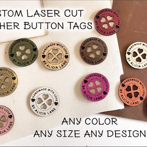 May include: Assortment of custom laser cut leather button tags with a four-leaf clover design and the text "Handmade with Love by Alicia Lane". The tags are available in various colors and sizes.