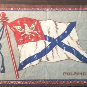 May include: A vintage fabric patch with a white flag with a red stripe and a blue cross. The flag has a white eagle with a crown on its head. The text "POLAND" is printed below the flag.
