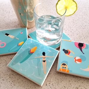 May include: Four blue and white ceramic coasters with a summer pool theme. Each coaster features a different illustration of people swimming, a flamingo float, and a surfboard.