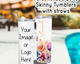 May include: Two 20oz stainless steel skinny tumblers with straws. One tumbler is white with the text "Your Image or Logo Here". The other tumbler has a floral design and the name "Amanda" written in cursive.