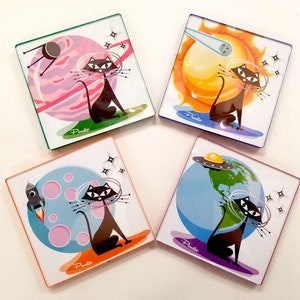 May include: Set of four square coasters featuring a black cat in a space-themed design. Each coaster has a different background, including a planet, a sun, a starry sky, and a globe. The coasters are made of a durable material and are perfect for protecting your furniture from scratches and spills.